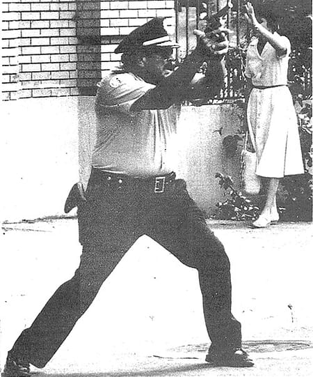 Policeman with pistol drawn